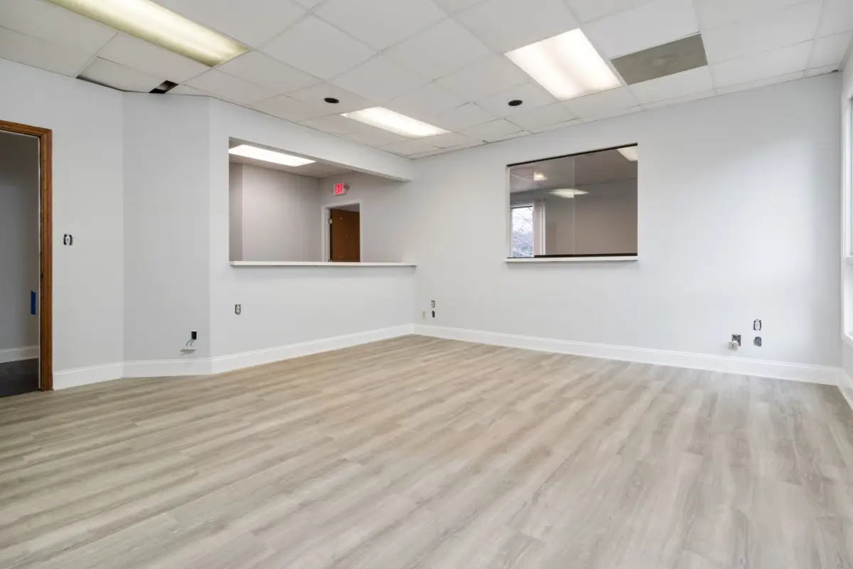 Finished commercial interior space with smooth walls and recessed lighting