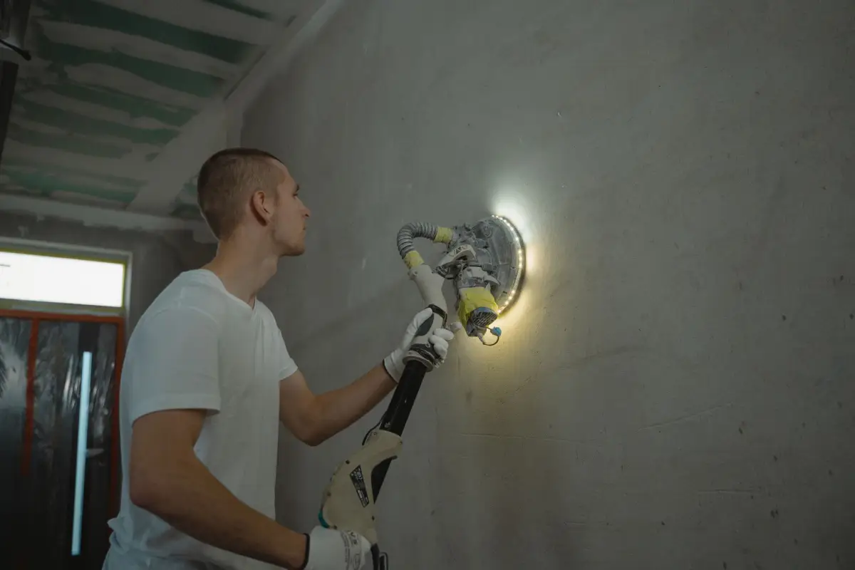 Sanding a drywall repair smooth before priming