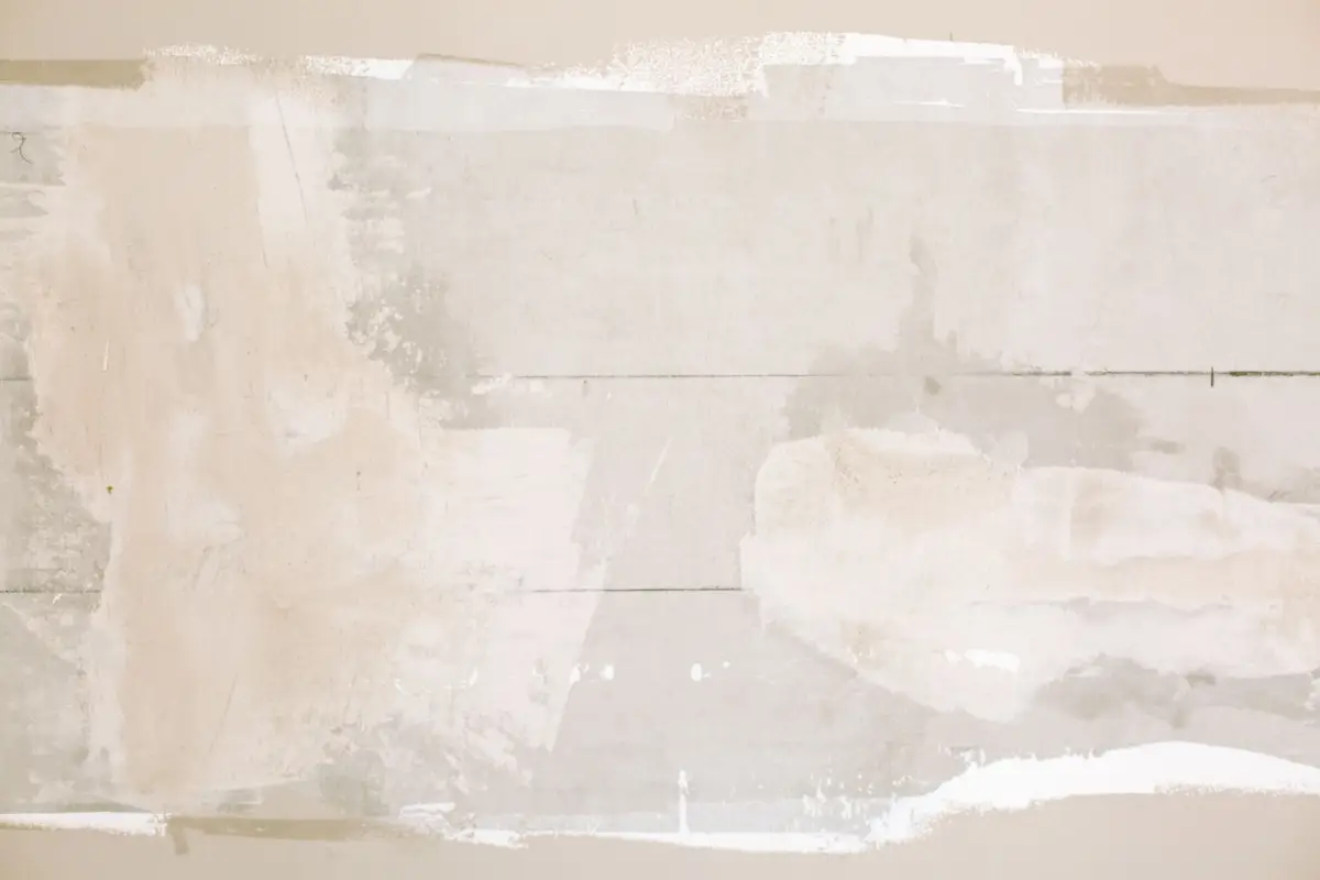 Close-up of an unfinished drywall patch showing texture before the final coat