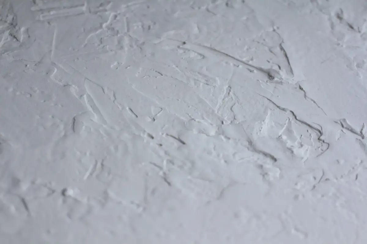 Close-up of a textured ceiling surface before popcorn removal